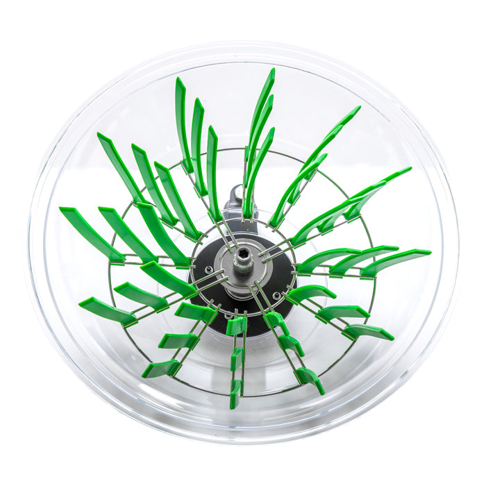 Close-up of a clear bowl with a rotating mechanism with green blades.