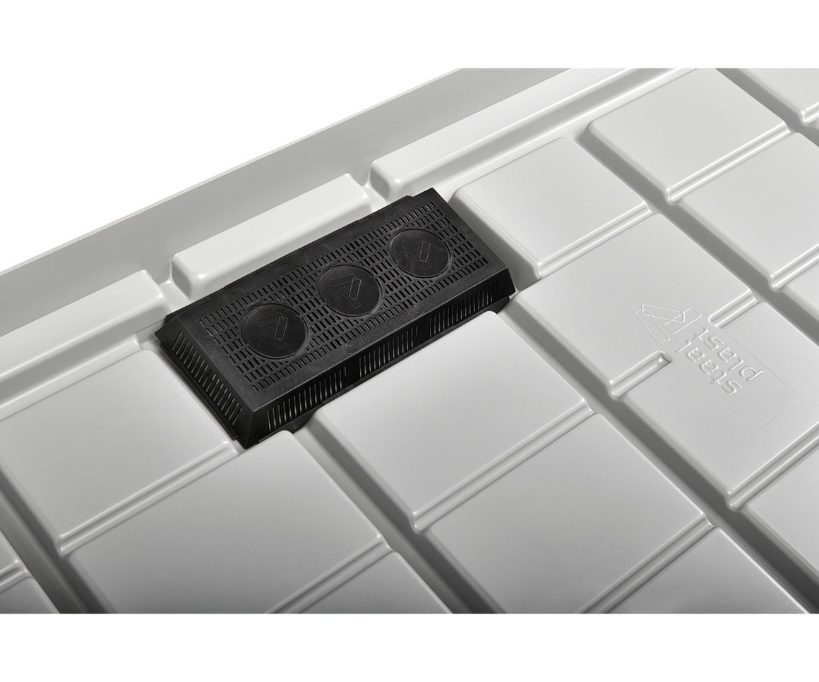 Close-up of a black drain screen with three circular openings on a white, textured grow tray.