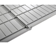 A close-up, angled view of a grey hydroponic tray with multiple channels and a drainage gutter.
