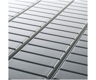 Close-up of a gray slatted shelf, showing parallel rows of smooth, rectangular bars with dark shadows.