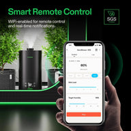 VIVOSUN AeroStream H05 smart humidifier and plants. Hand uses smartphone app for Wi-Fi remote control, showing humidity.