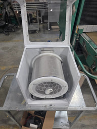 Amped Mini Extraction Tumbler with mesh cylinder, hex pattern filter, and clear lid, on a metal cart.