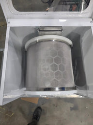 Amped Mini Extraction Tumbler: A metallic mesh cylinder with a honeycomb pattern, housed in a white machine.