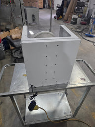 White extraction tumbler with clear top on metal cart, with power cord attached.