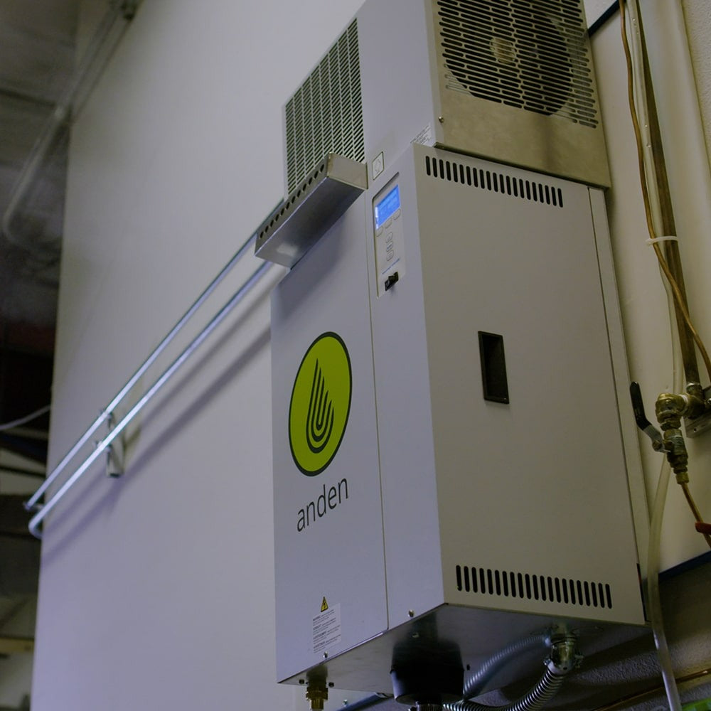White Anden AS35FP steam humidifier mounted on wall, with green logo and blue display.