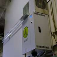 White Anden AS35FP steam humidifier mounted on wall, with green logo and blue display.