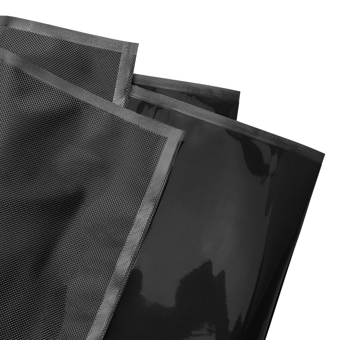 Black vacuum seal bags with a textured grid pattern, stacked and overlapping.