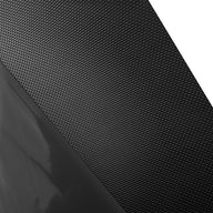 Close-up of textured black material with a glossy black surface and white background.