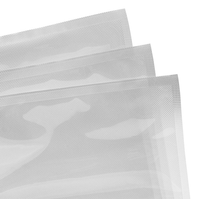 Three clear vacuum seal bags with textured surfaces, stacked and angled against a white background.