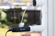 Bluelab pH probe screwed into white PVC pipe fitting with a white cable leading to a black sensor.