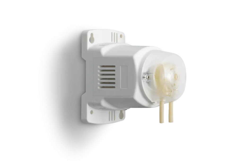White peristaltic pump with clear casing and two tubes against a black and white background.