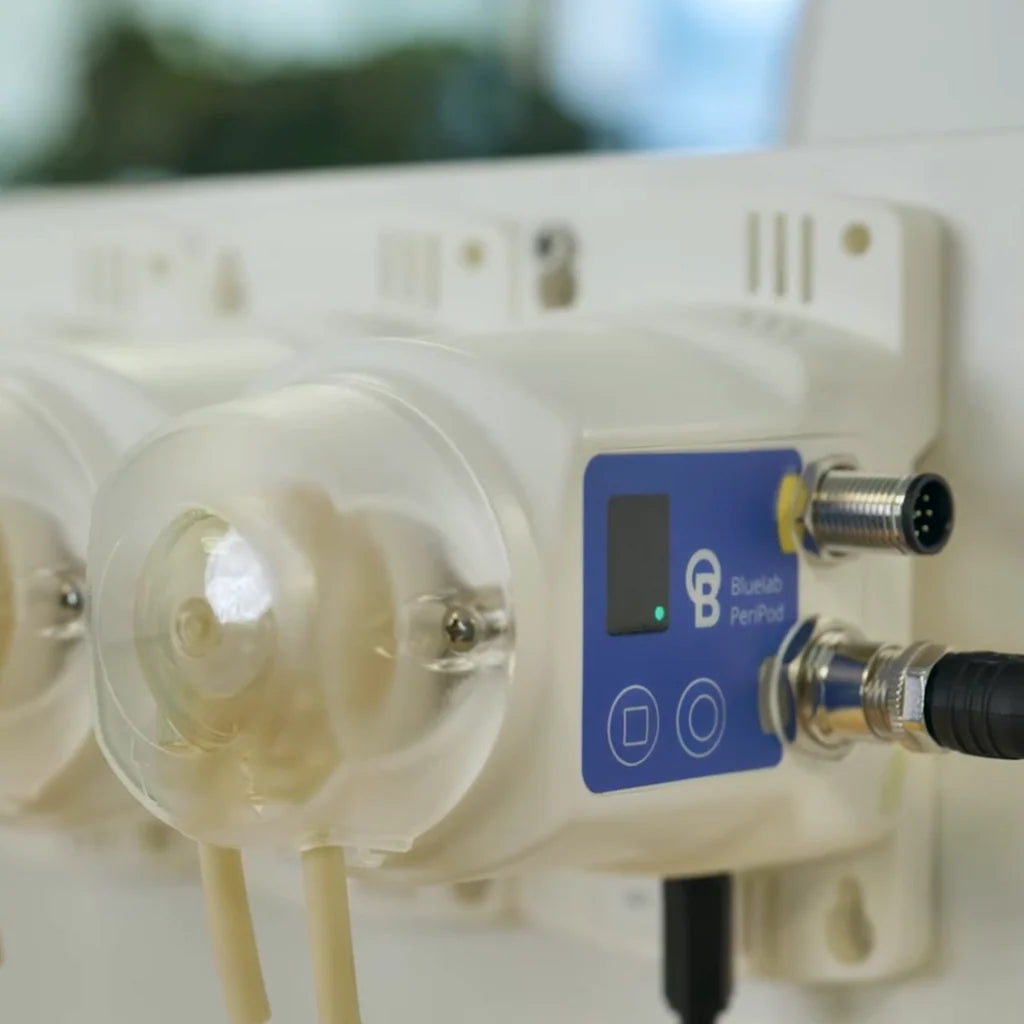 Bluelab PeriPod peristaltic pump with clear casing and blue control panel.