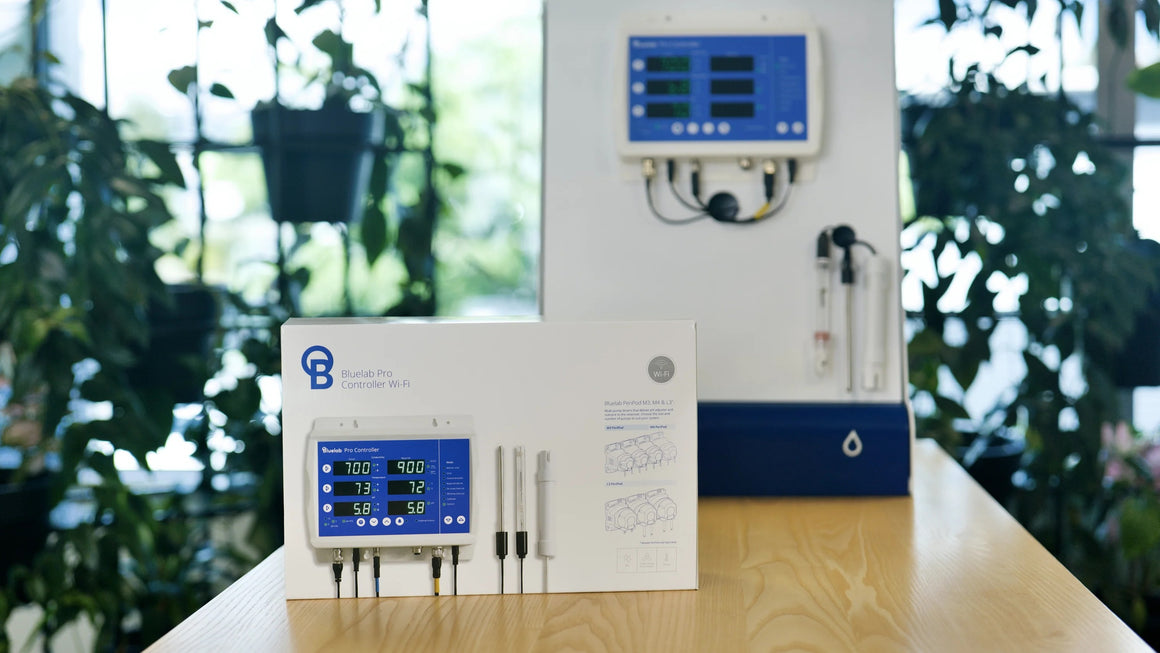 Bluelab Pro Controller Wi-Fi box with a mounted unit and sensors, featuring a blue display with readings for conductivity, temperature, and pH.