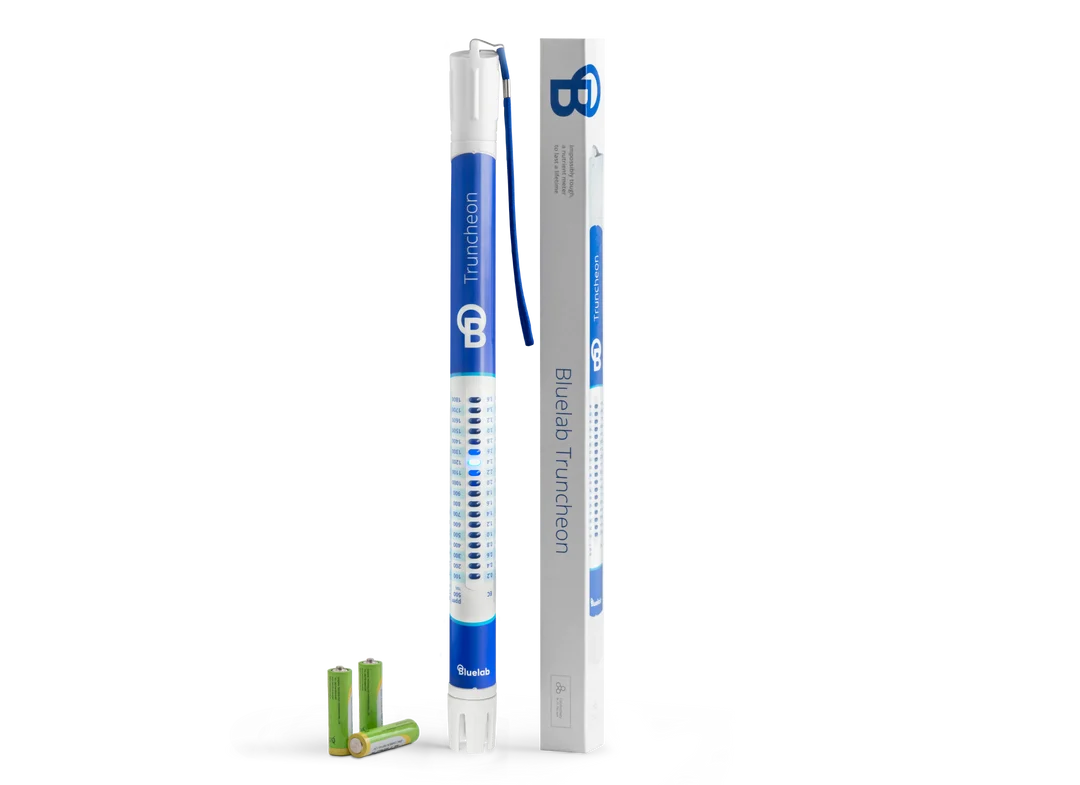 Bluelab Truncheon nutrient meter with packaging and batteries on a black background.