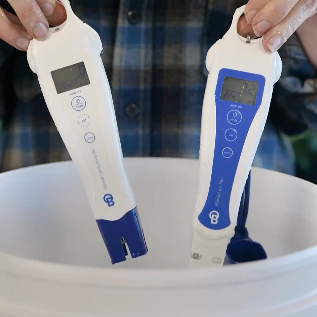 Bluelab pH and Conductivity pens in a white bucket, one reads 7.2, 22°C.