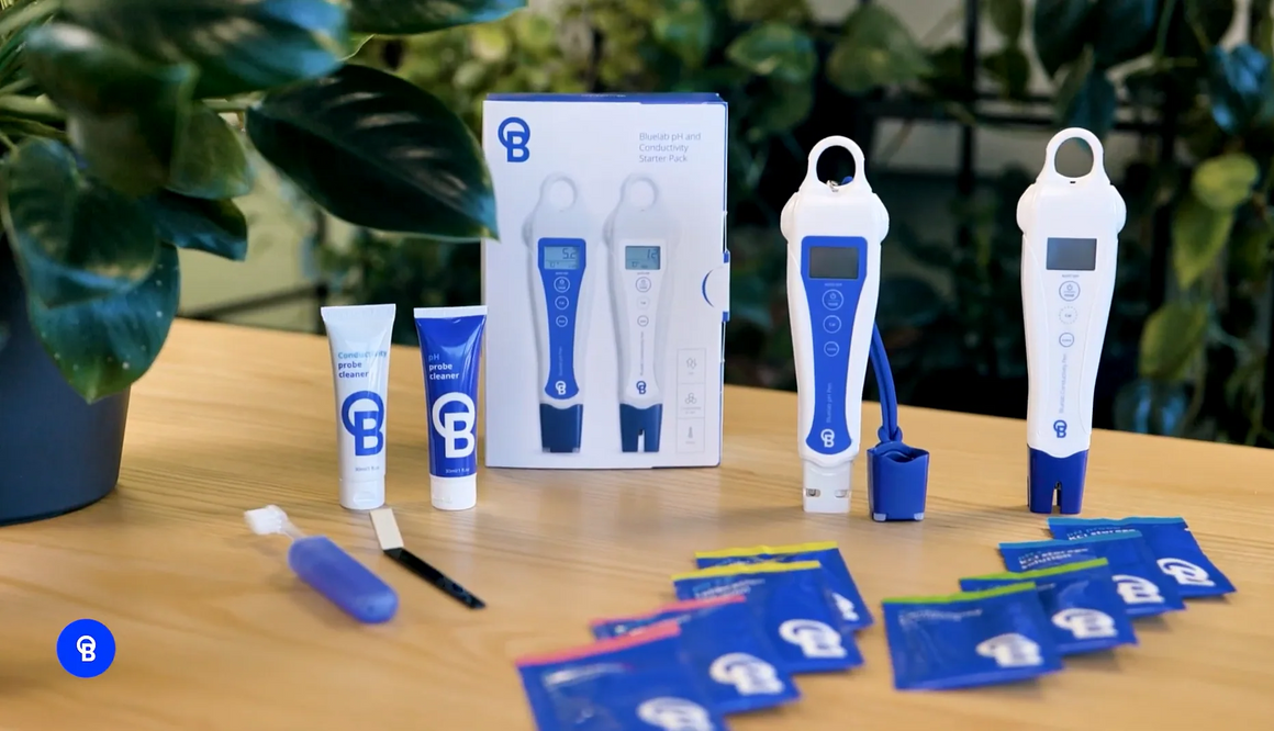 Bluelab pH and Conductivity Starter Pack with meters, cleaners, and sachets on a wooden table.
