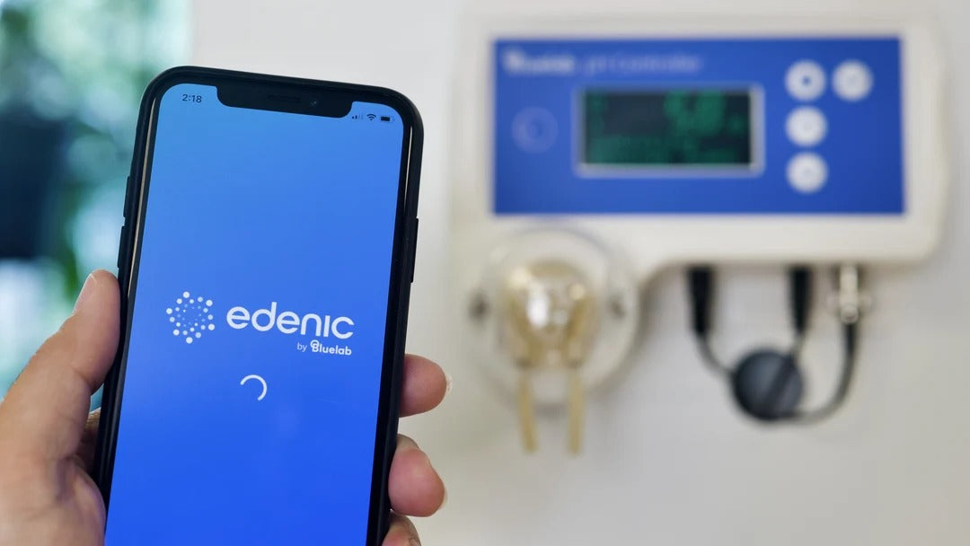 iPhone displays "edenic by Bluelab" app near a Bluelab pH controller.