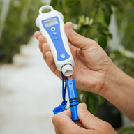Person holding a Bluelab pH pen and probe, preparing to attach them.