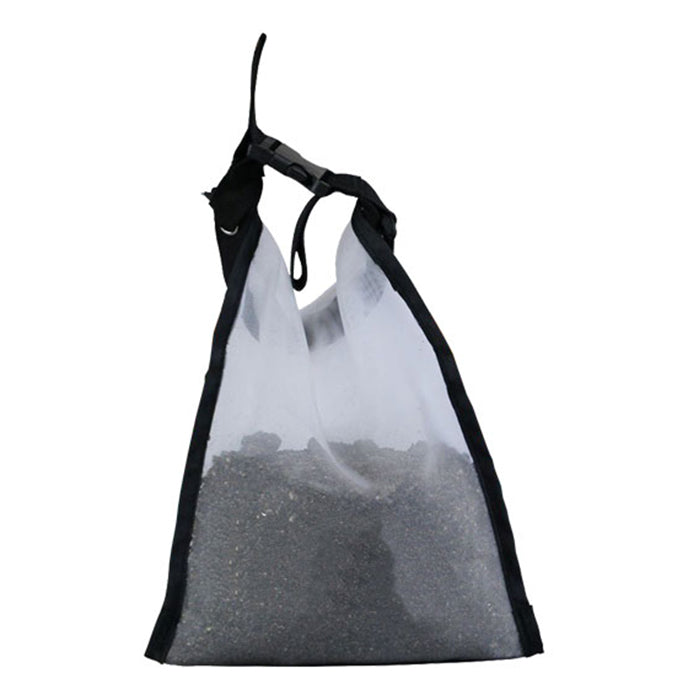 Mesh tea bag filled with loose leaf tea, suspended by drawstring and buckle.
