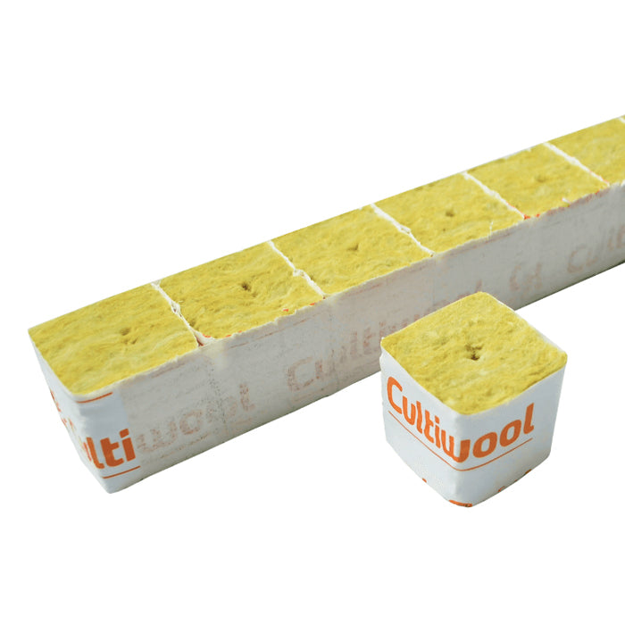 Cultiwool rockwool hydroponic growing media. Yellow seed starter cubes with holes, one separated from a scored strip.