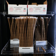 Product display of pre-rolled cones in a humidor, with product boxes above.