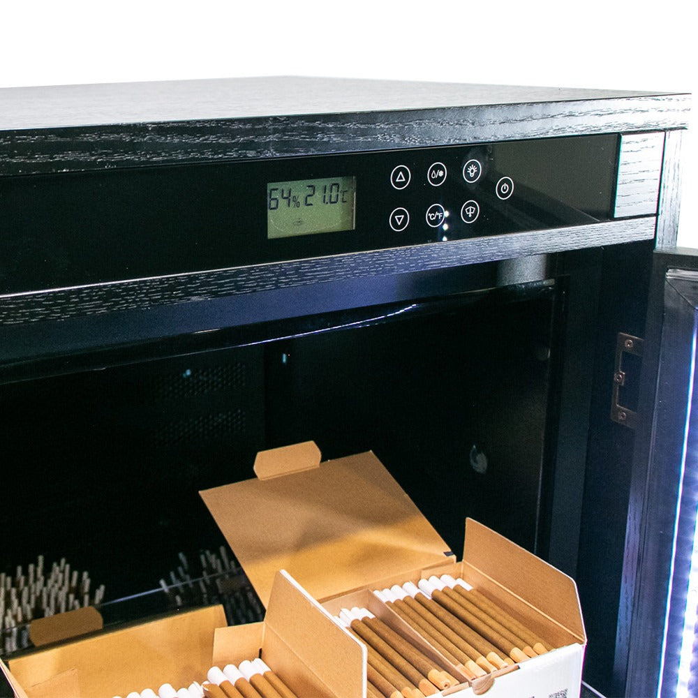 Black humidor with digital display showing 64% humidity and 21.0°C, open boxes of cigars inside.