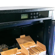 Black humidor with digital display showing 64% humidity and 21.0°C, open boxes of cigars inside.