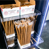 Product display of artisan pre-rolled cones in a black series humidor with LED lighting.
