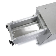 Stainless steel industrial grinder drawer with ruler measurement markings.