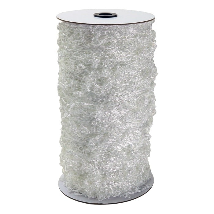 White ruffled netting roll on a spool with a dark center hole.