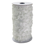 White ruffled netting roll on a spool with a dark center hole.