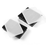 Two black silicone ice cube trays with white lids, presented on a white background.
