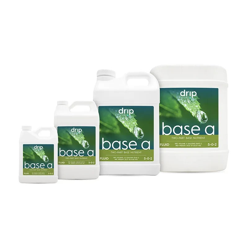 Four white plastic jugs of "drip base a" two-part base nutrient, showing green leaf labels with water drops.