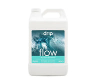 Drip Hydro Flow buildup preventer fluid in a white gallon jug with a label featuring a wave.