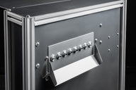 Close up of industrial metal case with silver fittings and connections.