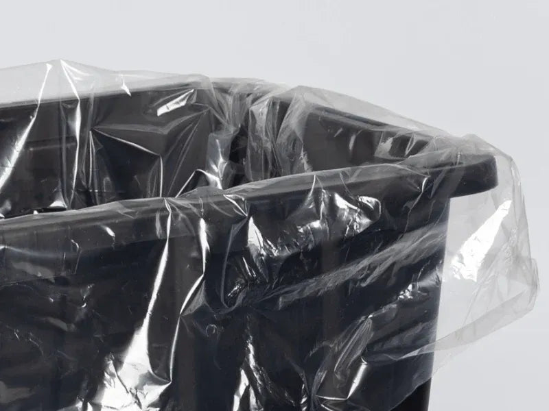 Clear plastic tote liner draped over the rim of a black 27-gallon tote.