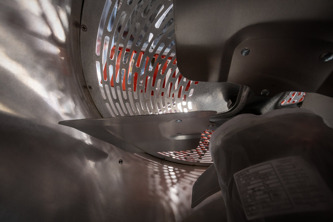 Close-up of internal components of a bud trimmer, showing fan blades, heating element, and a label.