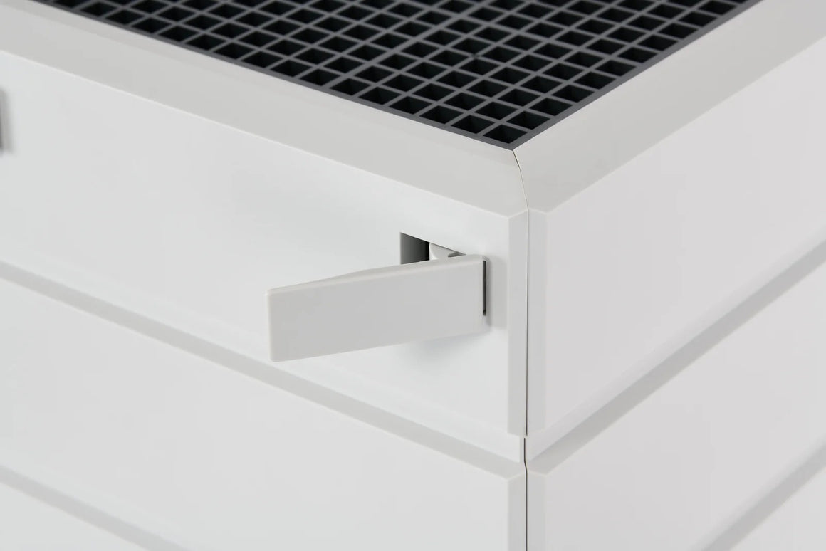 White air purifier with a grey grate top and a flip-out handle.