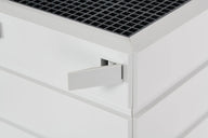 White air purifier with a grey grate top and a flip-out handle.