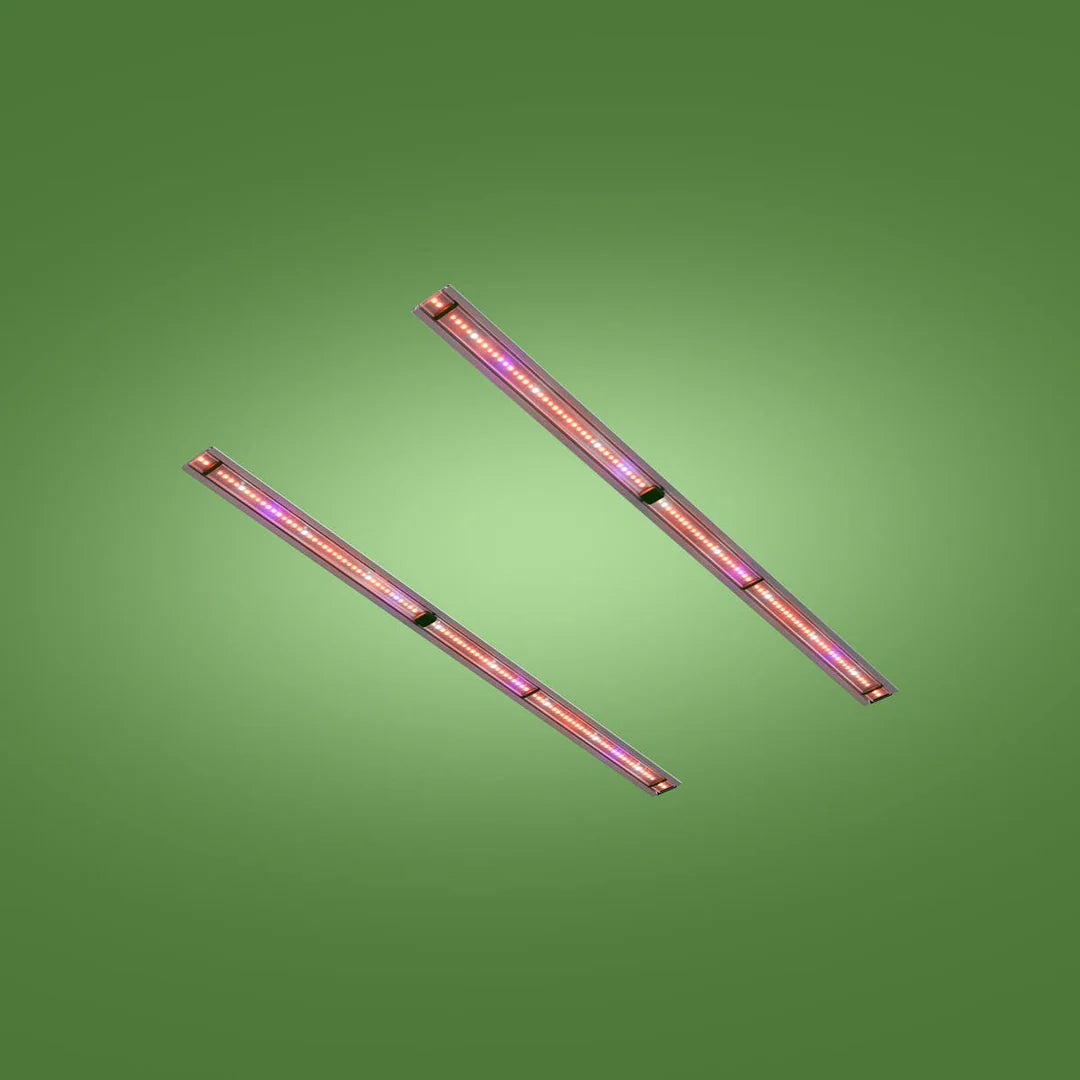 Two parallel Far-Red LED retrofit grow light bars glowing pink and red on a green background.