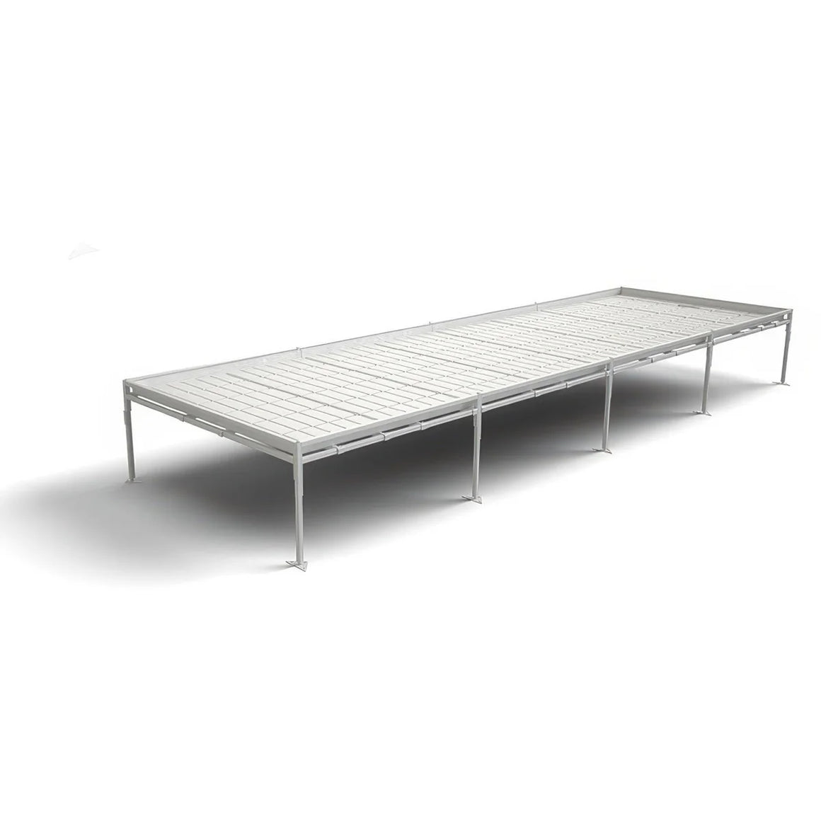 Long, white continuous bench system with metal legs, used for growing plants.
