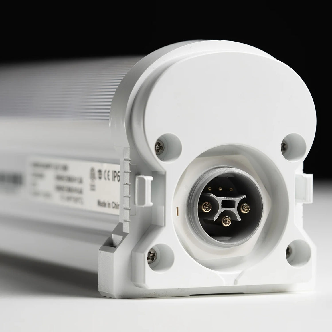 White waterproof light fixture with a multi-pin connector and CE IP6 rating.