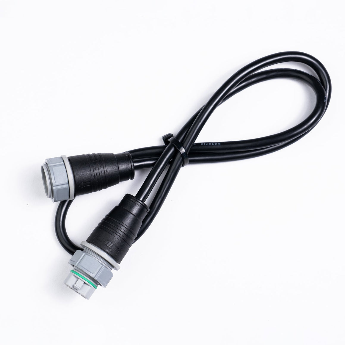 Black cable with two gray and black connectors, one with a green ring, against a white background.