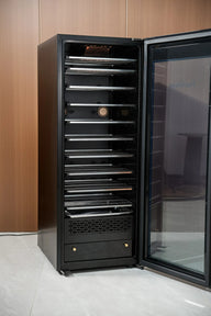 A tall, black, smart drying and curing cabinet with multiple metal shelves and a glass door.