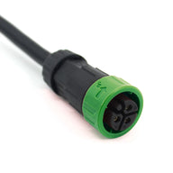 Black 277V LED light power cord with a 4-pin connector, black body, and green locking ring with an UP arrow.