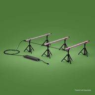 FloraFlex 3-bar system: three magenta LED grow lights on black tripod stands with power unit on green.