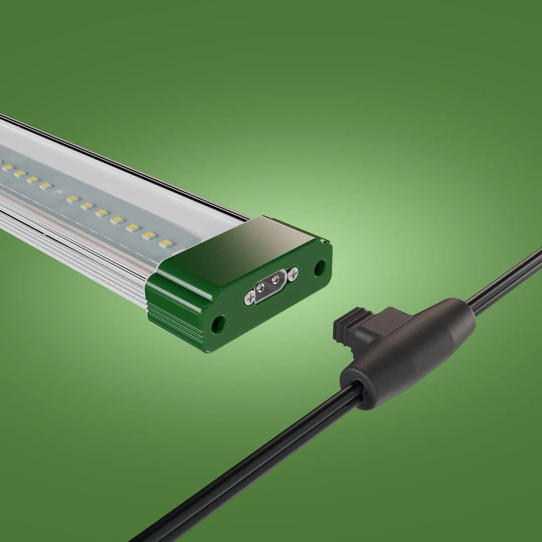 FloraFlex 3-bar LED grow light with green end cap, Far Red port, and black connector cable against a green background.