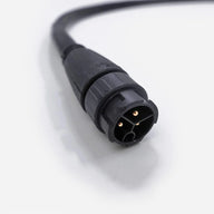 Black 3-pin electrical power cord connector with visible gold pins on a clean white background.