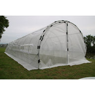 Heavy-duty tunnel greenhouse hoop house with clear plastic cover and roll-up windows, set on green grass.