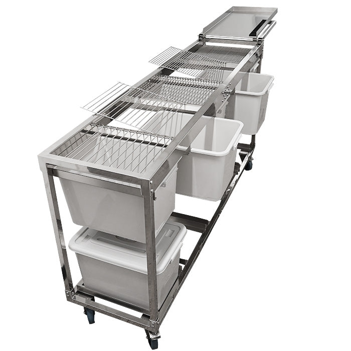 Long stainless steel harvest sorting system on wheels, featuring wire grates and multiple white storage bins.